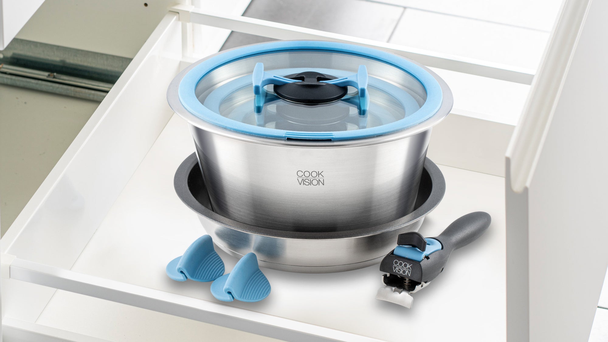 Stainless steel pot with lid on a white surface, featuring blue accents and 'Cook Vision' branding.